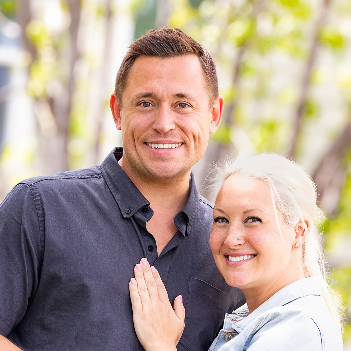 happy-couple-in-front-of-house-1129×1129